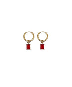 Gold hoop earrings with red rectangular charms on a white background