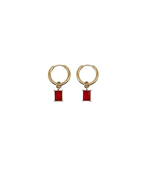 Gold hoop earrings with red rectangular charms on a white background